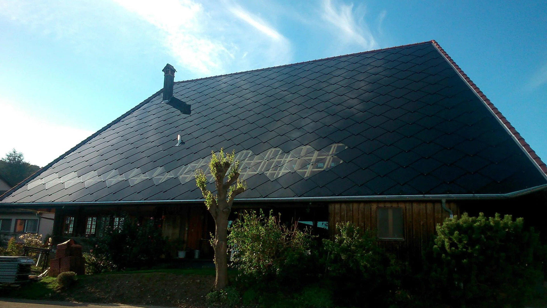 Sunstyle solar tiles installed on a roof with skylights