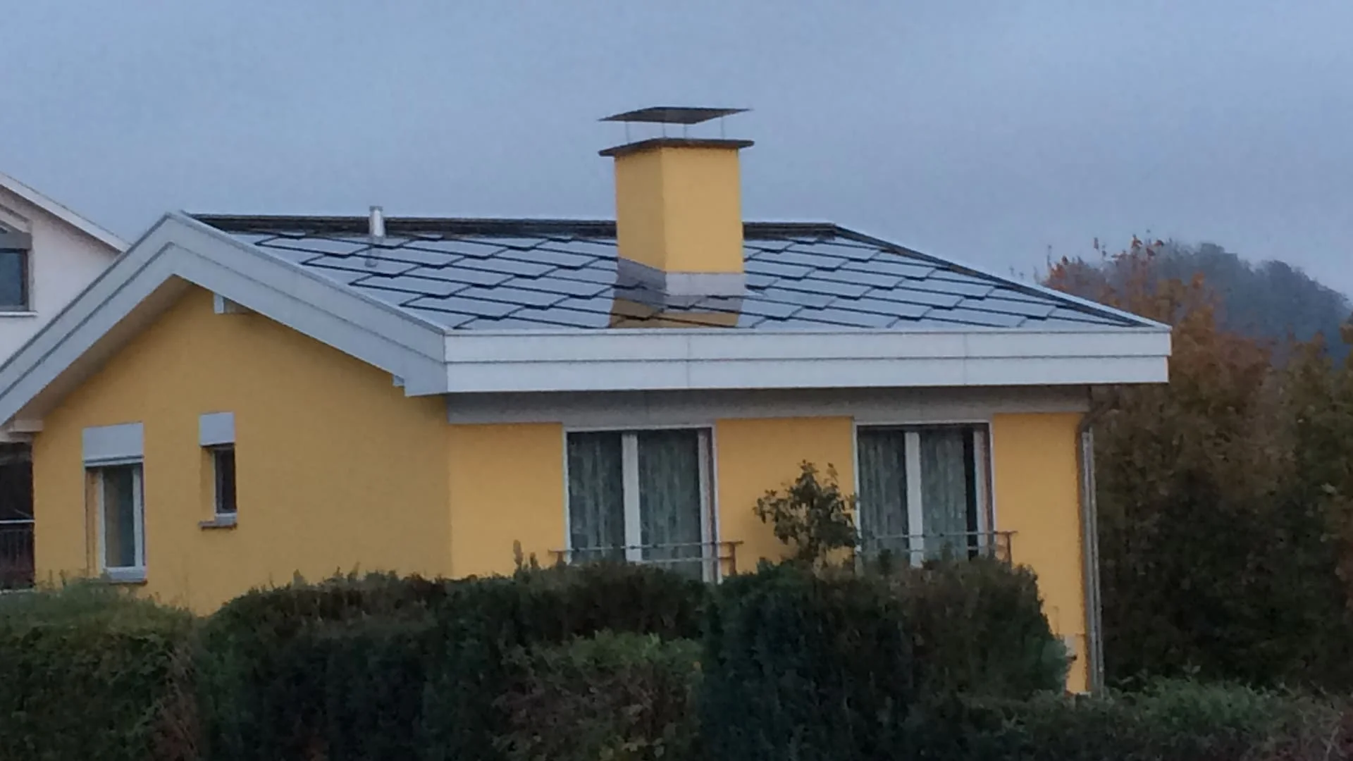 SunStyle Solar tiles on single family residence with a low pitch solar roof