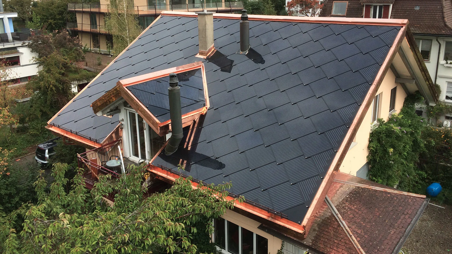 SunStyle solar tiles on a multi-family housing building where active solar tiles cover all areas that receive maximum sunlight.