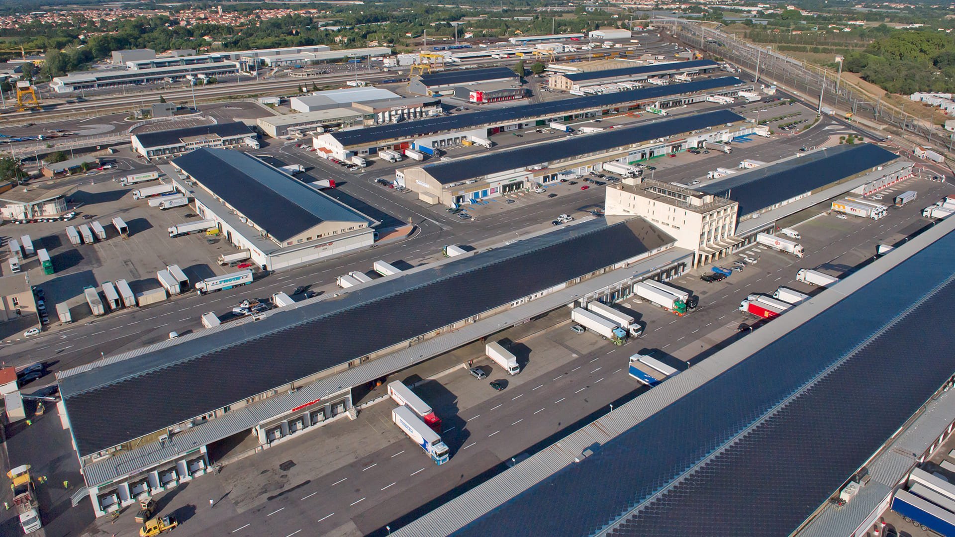 SunStyle sustainable solar roof on a large industrial warehouse complex that generates enough electricity to power the full warehouse and the nearby town