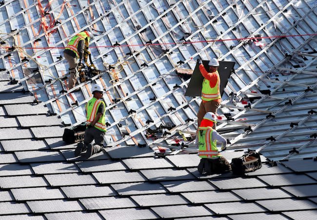 Google office building install worker dragonscale solar roof