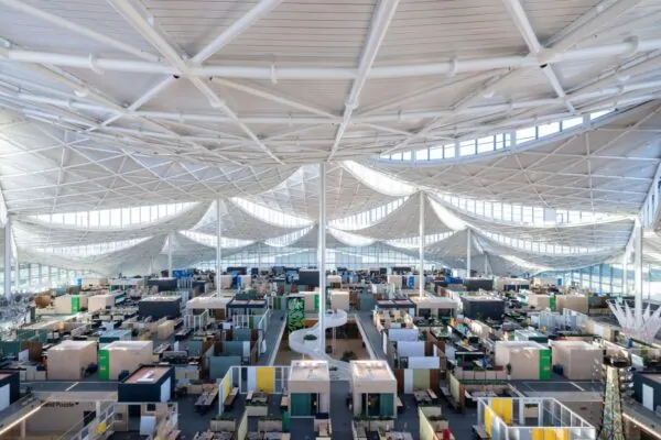 A bird's- eye view of the second floor workspace at Bay View shows how thousands of Googlers can be in a connected space with individual team neighborhoods under an inspiring canopy. Dragonscal | SunStyle