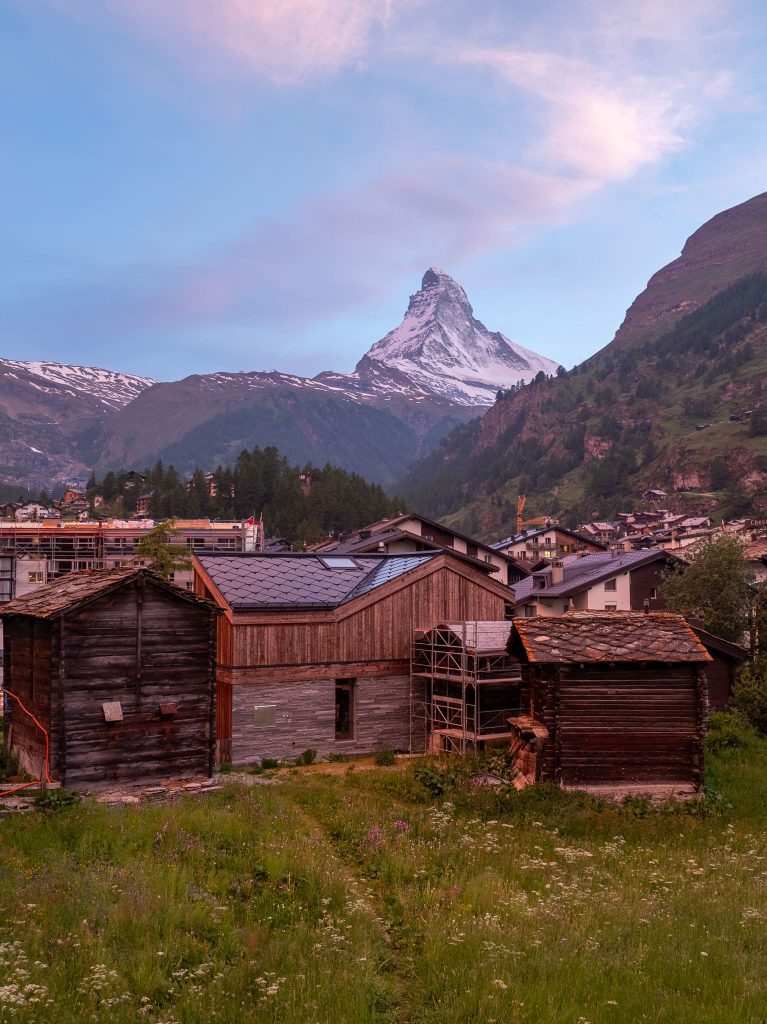 Chalet Nirvana, Zermatt – SunStyle solar roof on a cross-gable design, preserving alpine luxury.