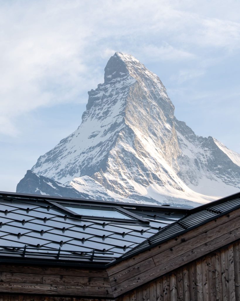 Chalet Nirvana, Zermatt – SunStyle solar roof on a cross-gable design, preserving alpine luxury.