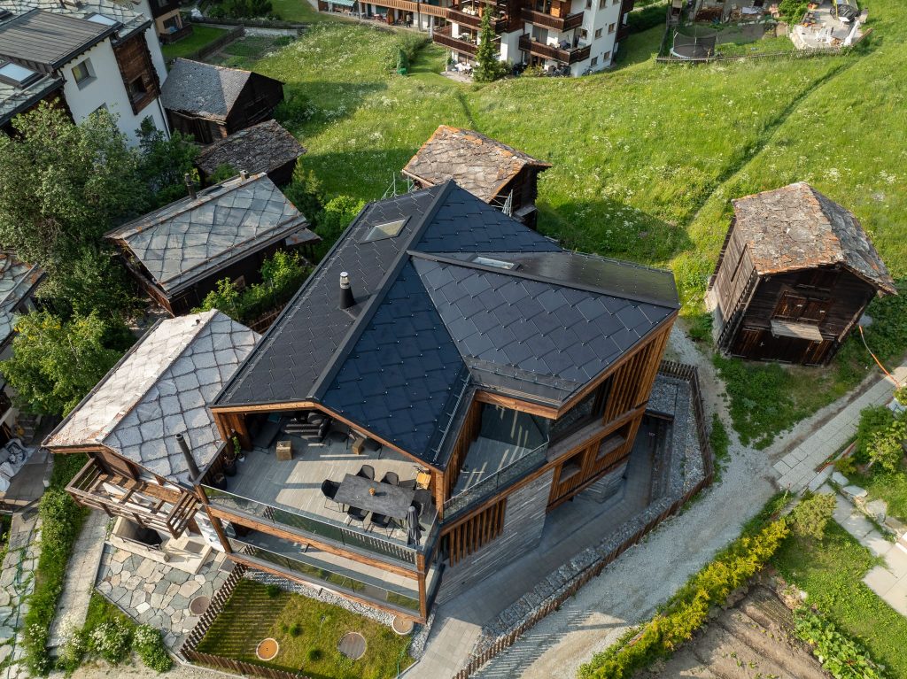 Chalet Nirvana, Zermatt – SunStyle solar roof on a cross-gable design, preserving alpine luxury.