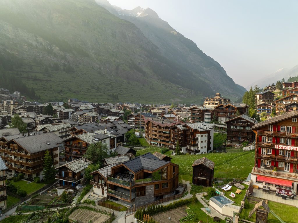 Chalet Nirvana, Zermatt – SunStyle solar roof on a cross-gable design, preserving alpine luxury.