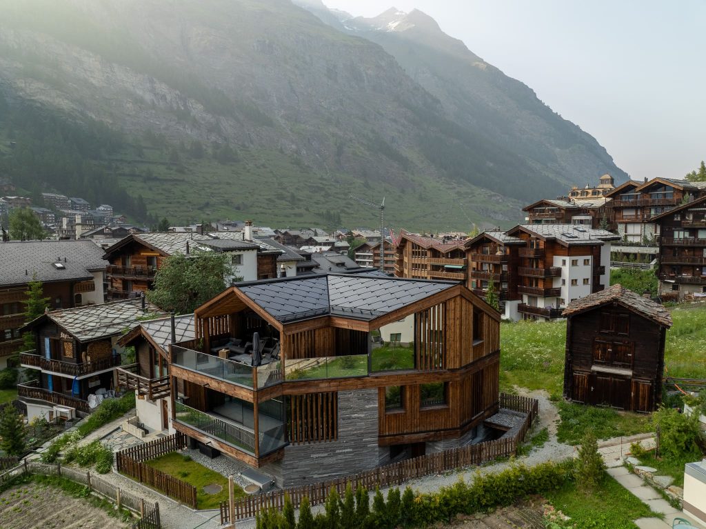Chalet Nirvana, Zermatt – SunStyle solar roof on a cross-gable design, preserving alpine luxury.