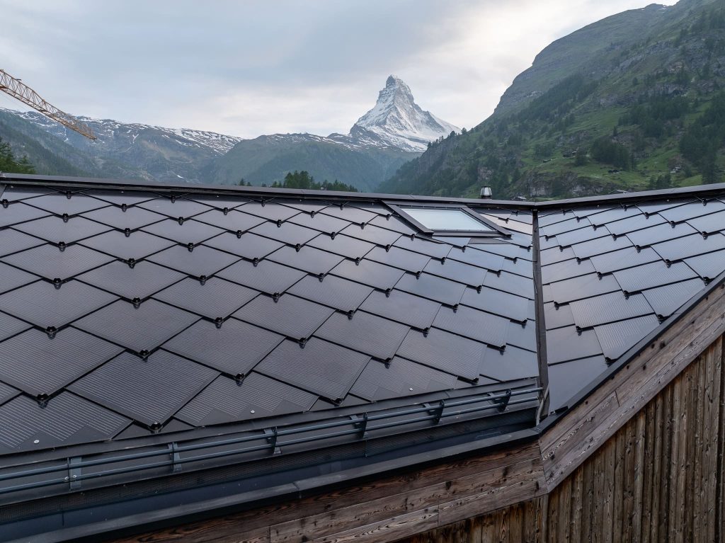 Chalet Nirvana, Zermatt – SunStyle solar roof on a cross-gable design, preserving alpine luxury.
