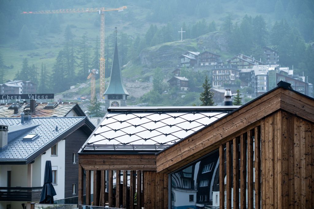 Chalet Nirvana, Zermatt – SunStyle solar roof on a cross-gable design, preserving alpine luxury.