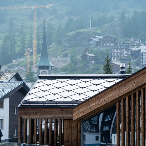 Chalet Nirvana, Zermatt – SunStyle solar roof on a cross-gable design, preserving alpine luxury.