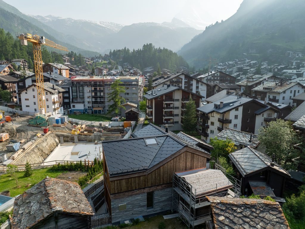 Chalet Nirvana, Zermatt – SunStyle solar roof on a cross-gable design, preserving alpine luxury.